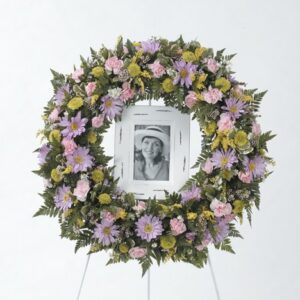 Large round memorial wreath around a picture